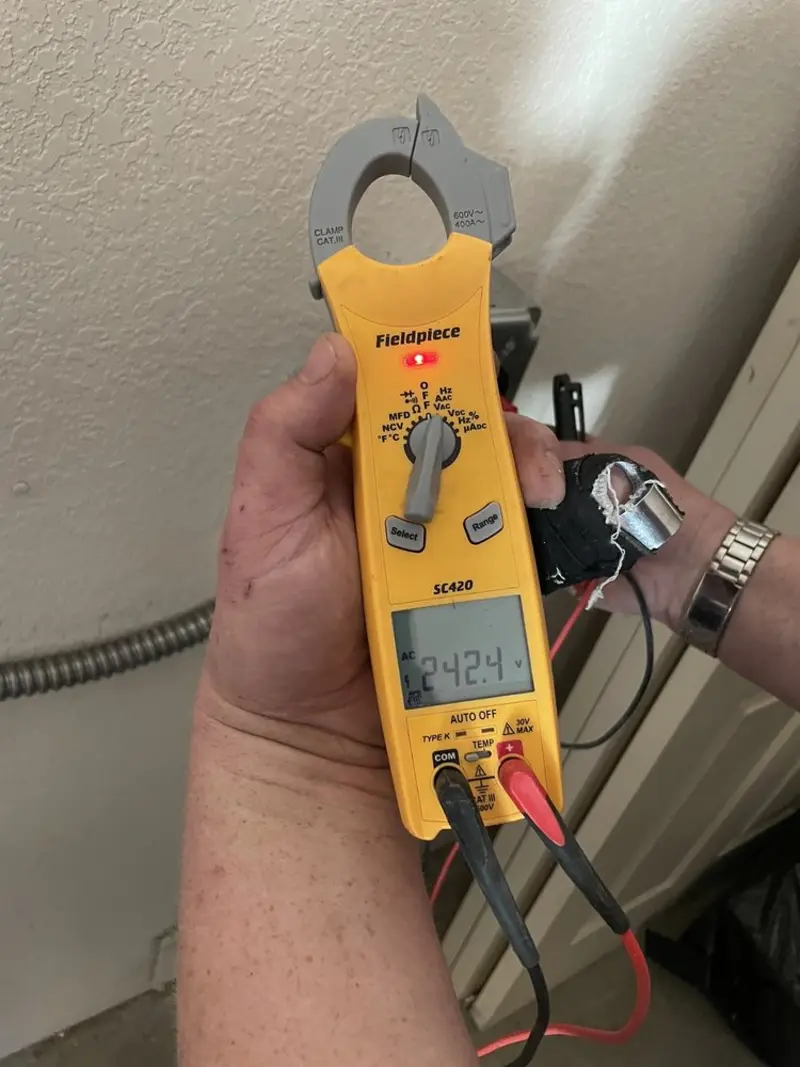 Voltage testing with clamp meter during Ceiling Fan Installation in Penn Forest